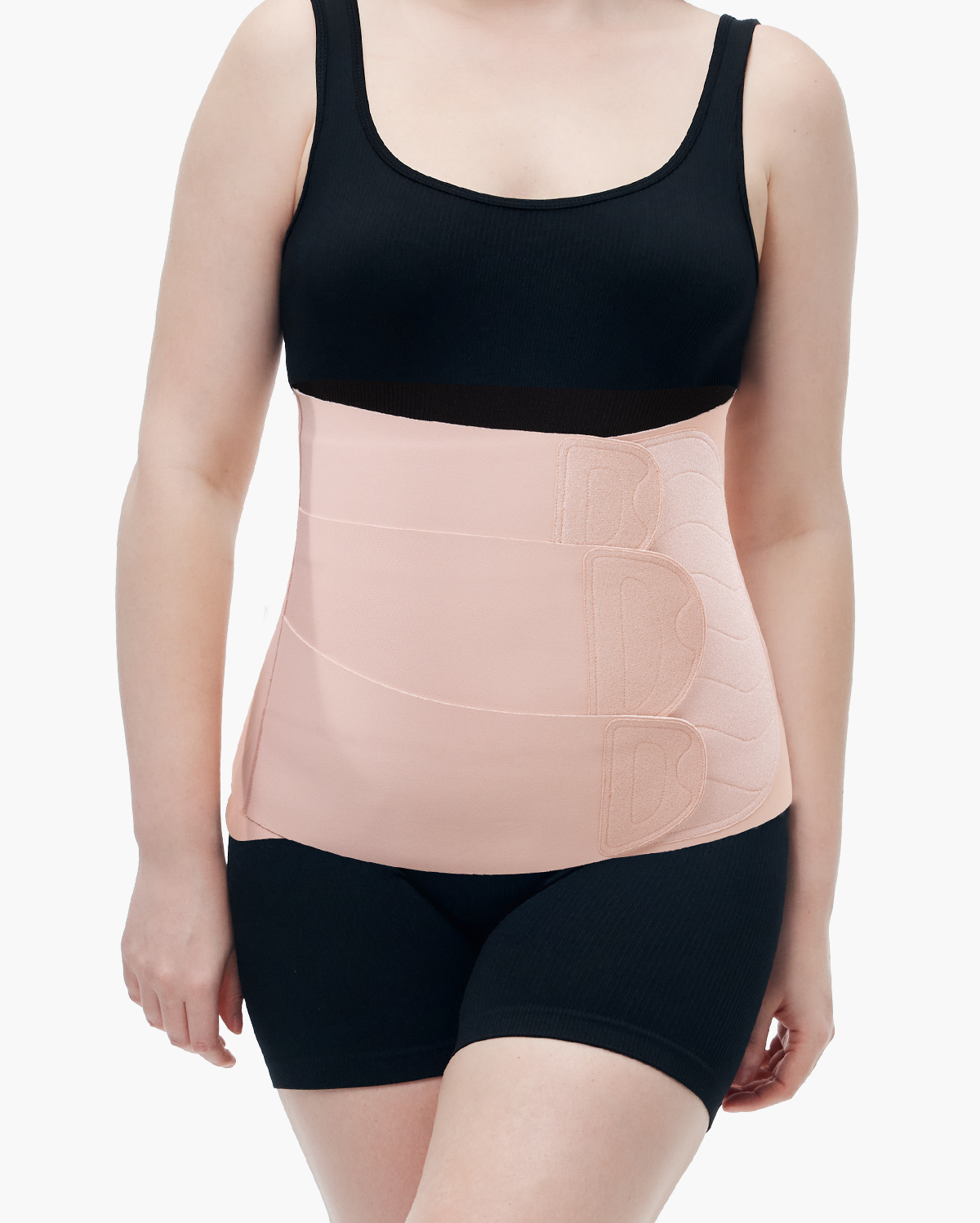 Momcozy Ergowrap Postpartum Belly Band in oyster pink color, worn over activewear, for postpartum support