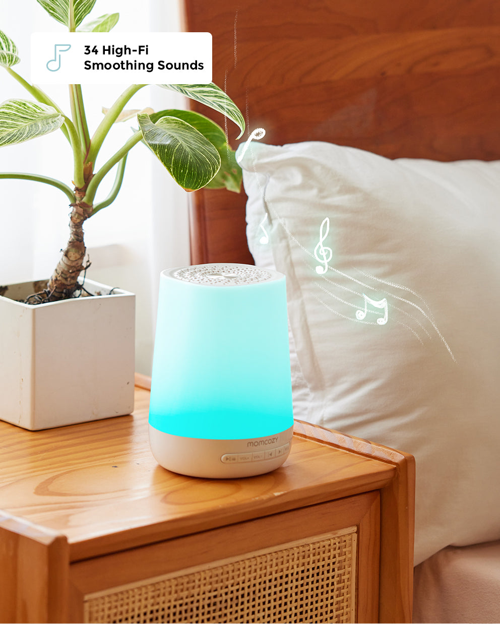 Smart Baby Sound Machine with 34 High-Fi Smoothing Sounds glowing blue, placed on a wooden nightstand next to a bed.