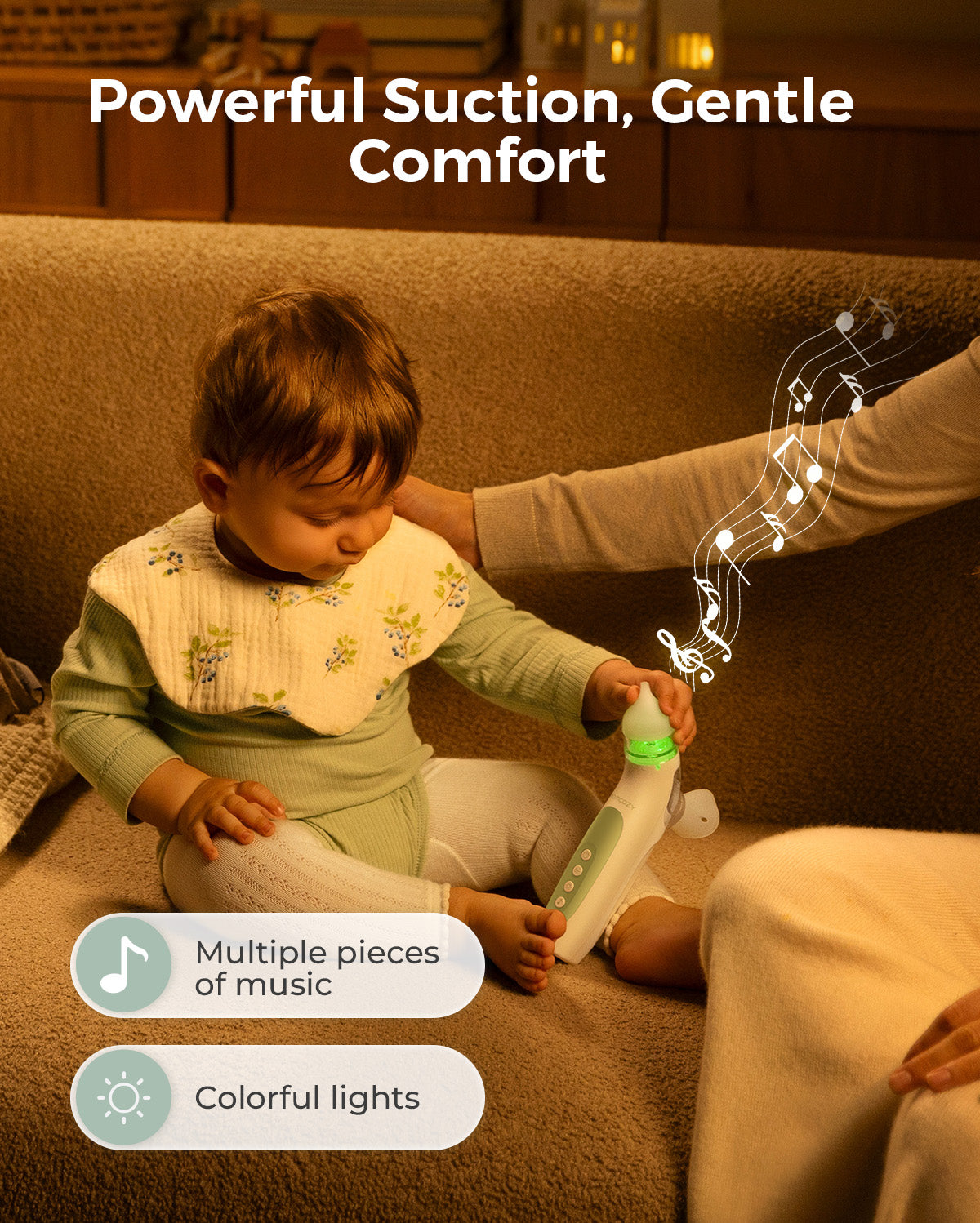 Momcozy electric nasal aspirator with music and lights, shown with a baby sitting on a couch.