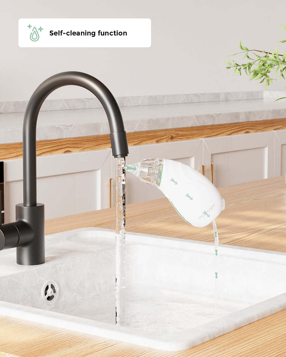 Momcozy baby nasal aspirator being cleaned under a running faucet, demonstrating its self-cleaning function.