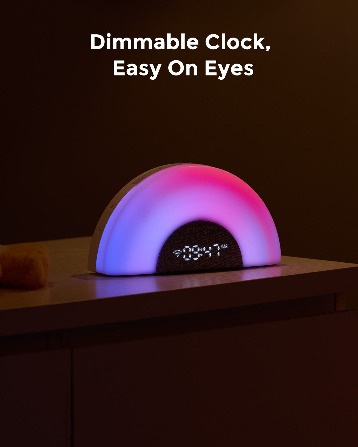 DreamSync smart baby sound machine displays 09:47 AM, emitting a colorful rainbow light. Features app control.