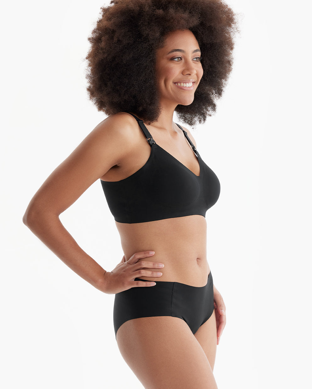 Smiling model wears black YN21 Ultra Soft Seamless Nursing Bra, showing comfortable V-neck and practical clips for M5 pump.